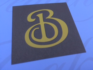yellow script b with brown background